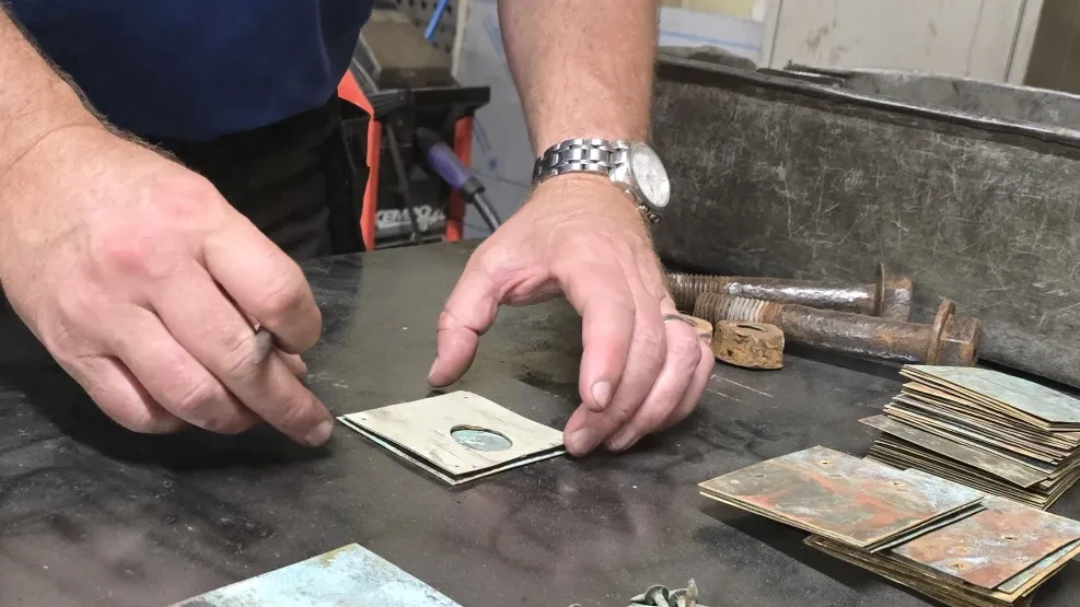 A man making a Bolt in wood ornament