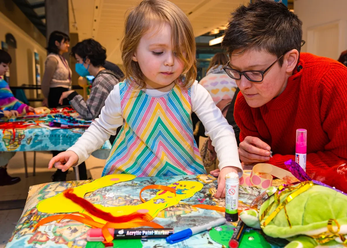 A child and parent enjoying colourful craft activities.