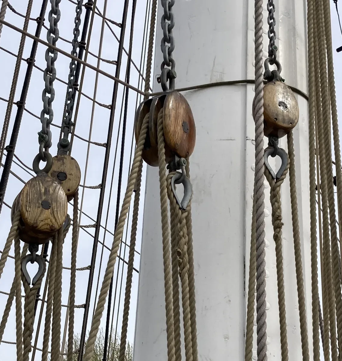Image of piece of ship rigging with blocks which are wooden squares that distribute rope and tackle