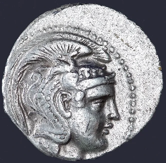 A tetradrachm commemorating the Battle of Salamis, 480 BC. Obverse: Head of Athene in a helmet within a pearled ring (right). Reverse: Within an olive wreath an owl seated on a prostrate amphora, the prow of a galley (right). Shows the trophy erected at Salamis. Greek inscription.