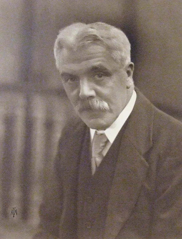Photograph of Frank Watson Dyson wearing a mustache and smart suit.