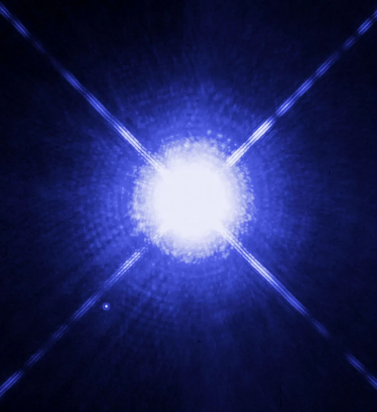 Large bright blue star centred in image, tiny blue star below and to the left.