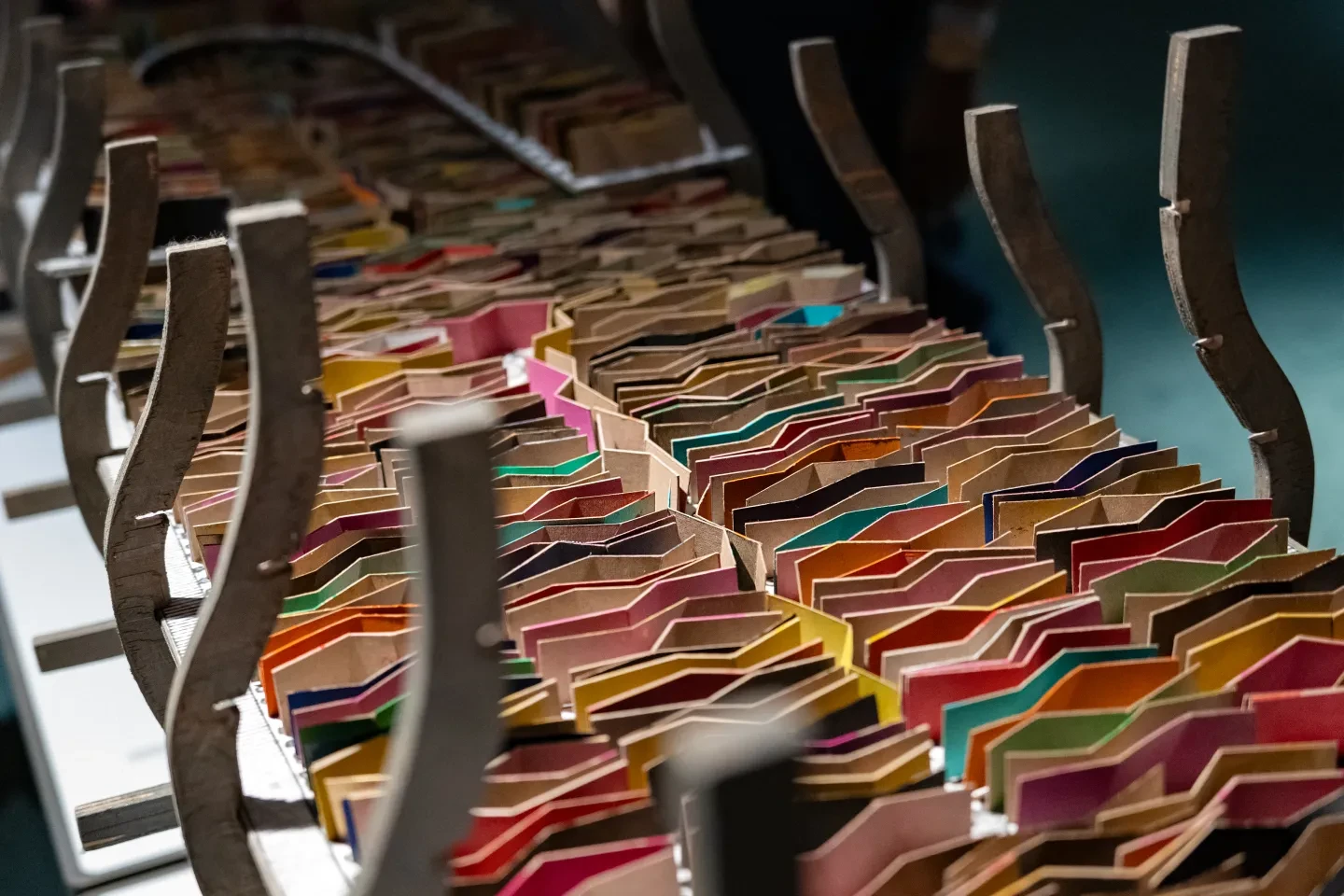 A model of a ship filled with colourful cardboard zigzag makers