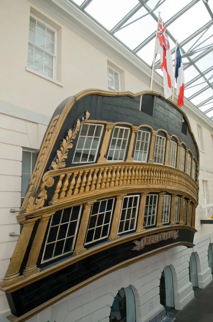 Starboard window from HMS Implacable with gold details