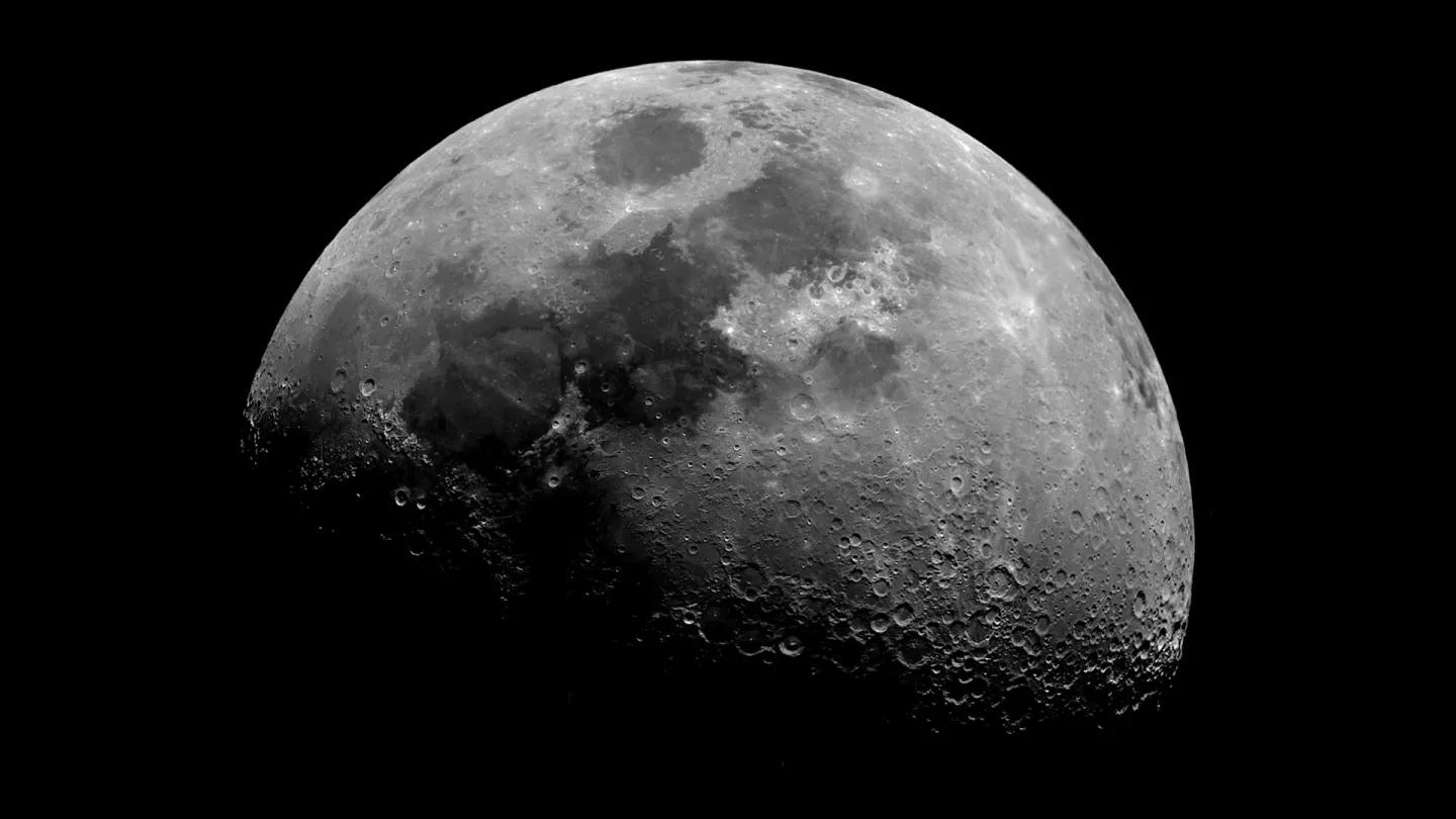 Photo of top half of the moon disappearing into darkness