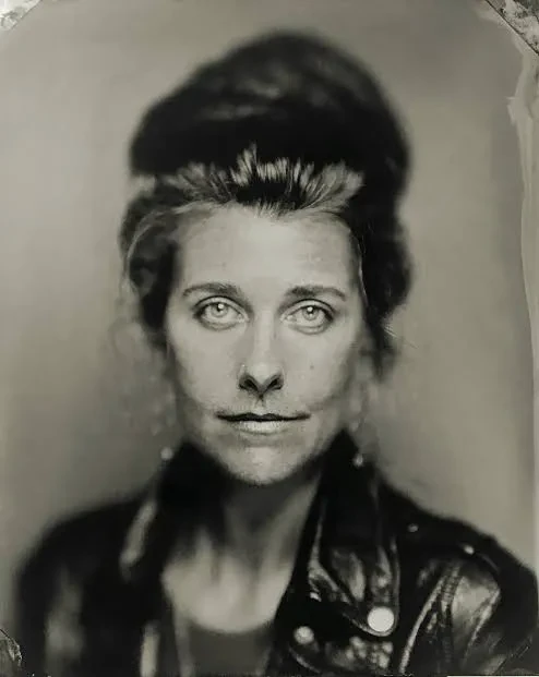 A black and white print of a headshot of artist Meghann Riepenhoff