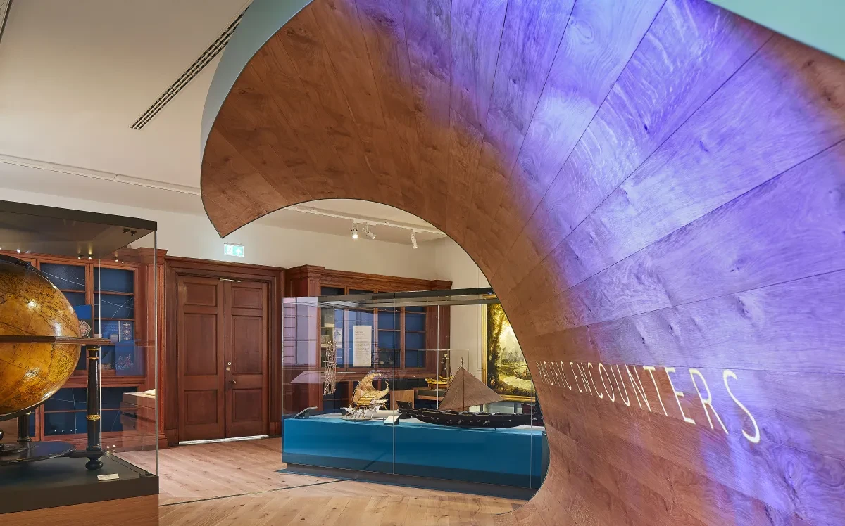 Entrance to the Pacific Encounters gallery featuring a crested wave