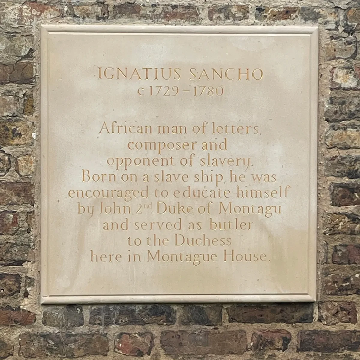 Plaque commemorating Ignatius Sancho in Greenwich Park. The dedication reads: 'IGNATIUS SANCHO - c1729-1780 - African man of letters, composer and opponent of slavery. Born on a slave ship he was encouraged to educate himself by John 2nd Duke of Montagu and served as butler to the Duchess here in Montague House.'