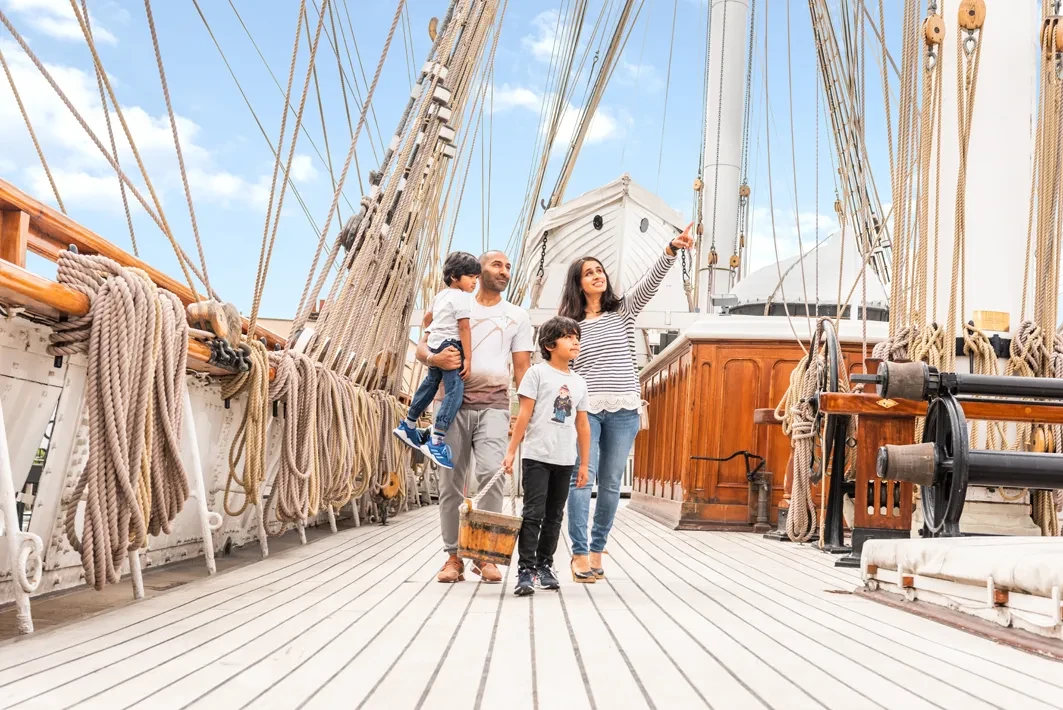 A family walking along the deck of Cutty Sark.