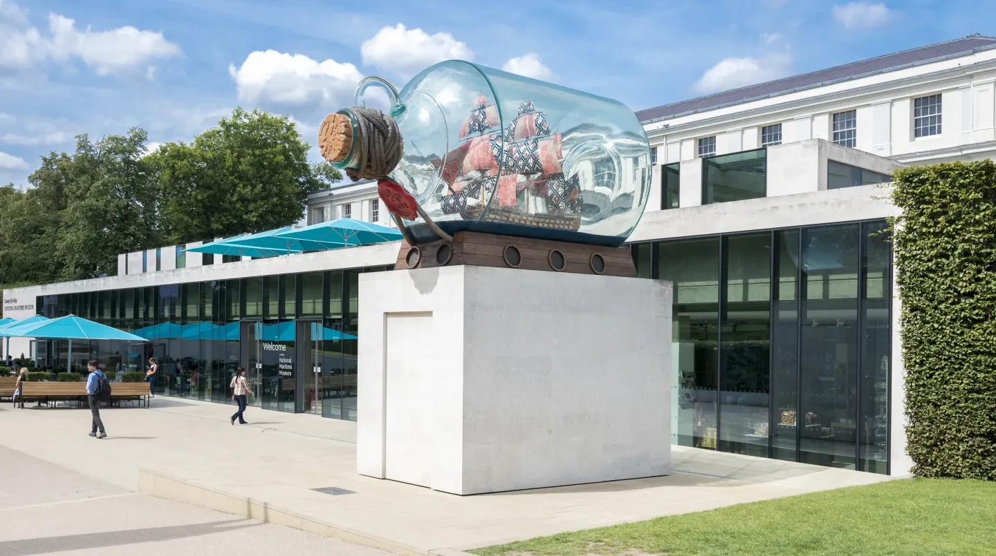 A model ship in a glass bottle in front of the National Maritime Museum.