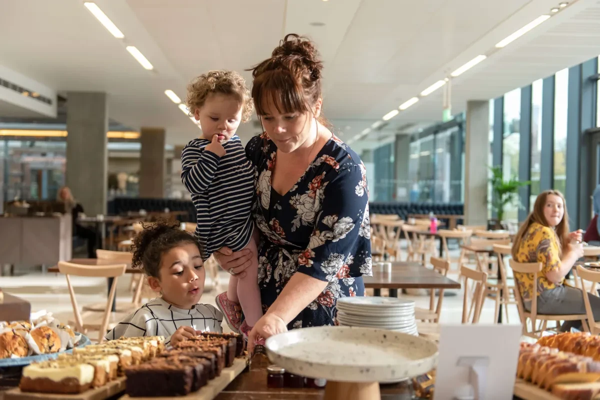 A mum and kids check out the café's cake selection.