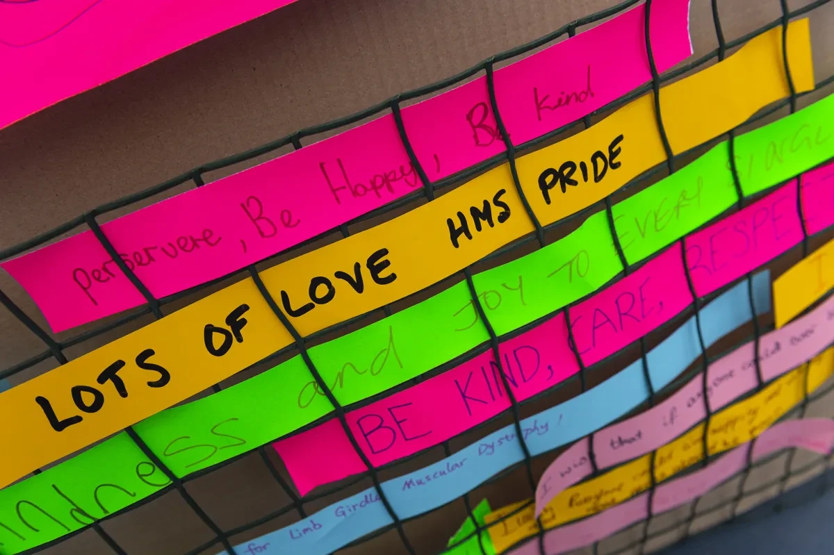 Brightly coloured sticky notes make up a rainbow display as part of an LGBT activity