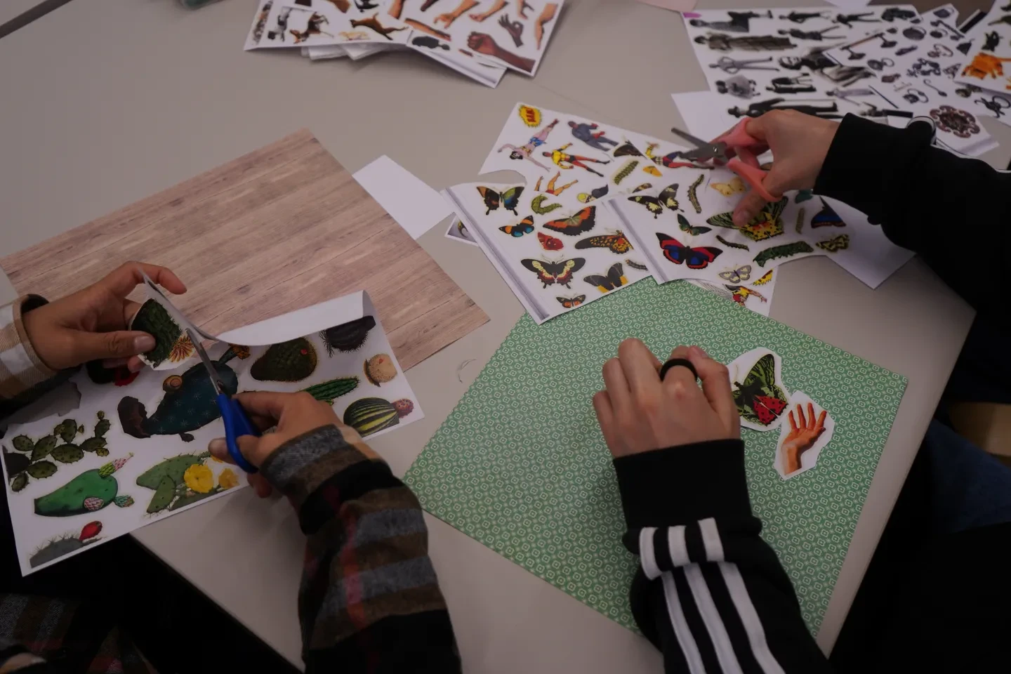 Saturday Art Club members cut out images from magazines to create collages