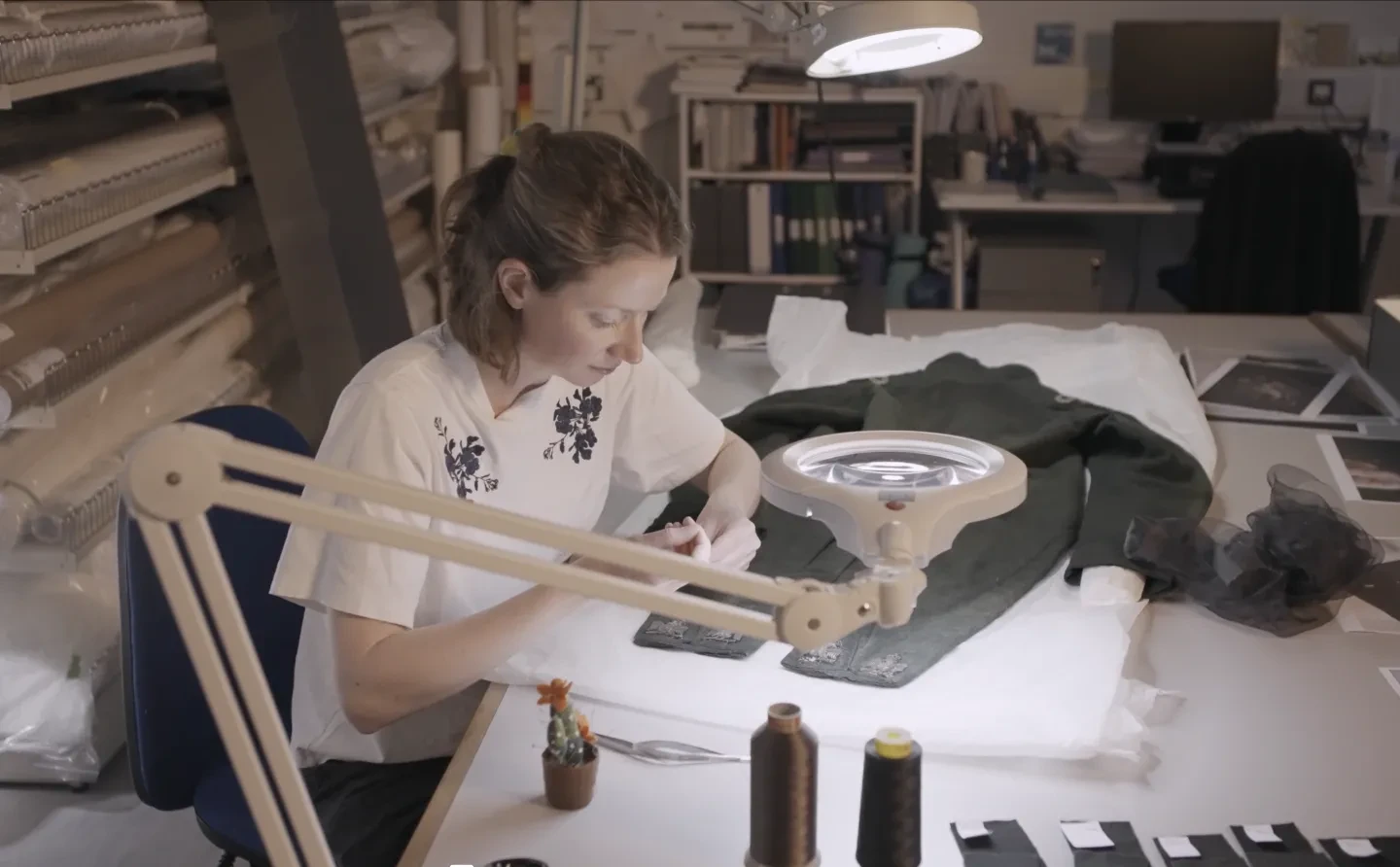Conservator Aisling Macken working on the embroidered eagles on the Hare uniform