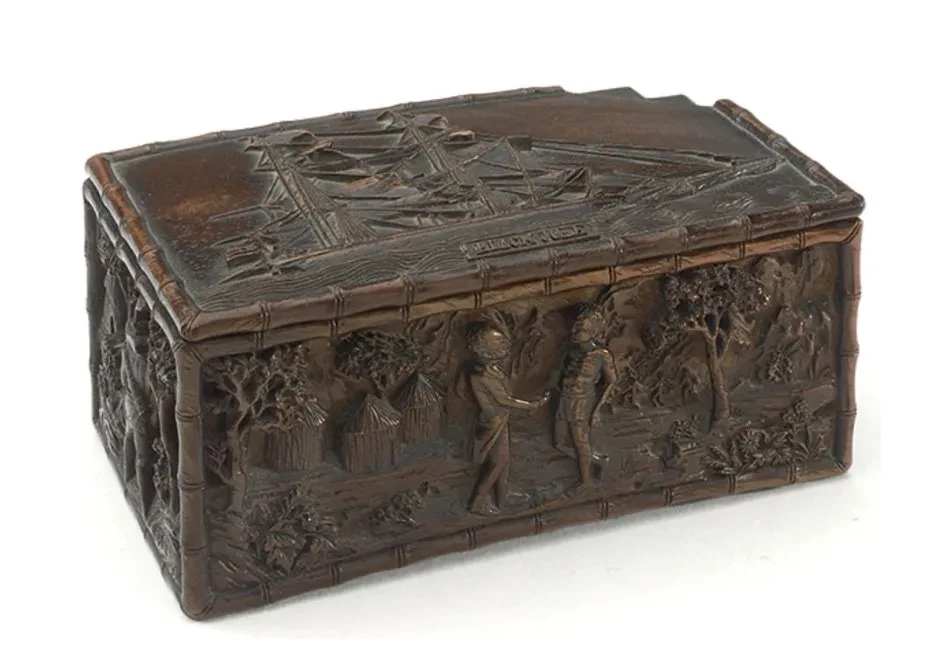 Small dark wooden box carved with figures