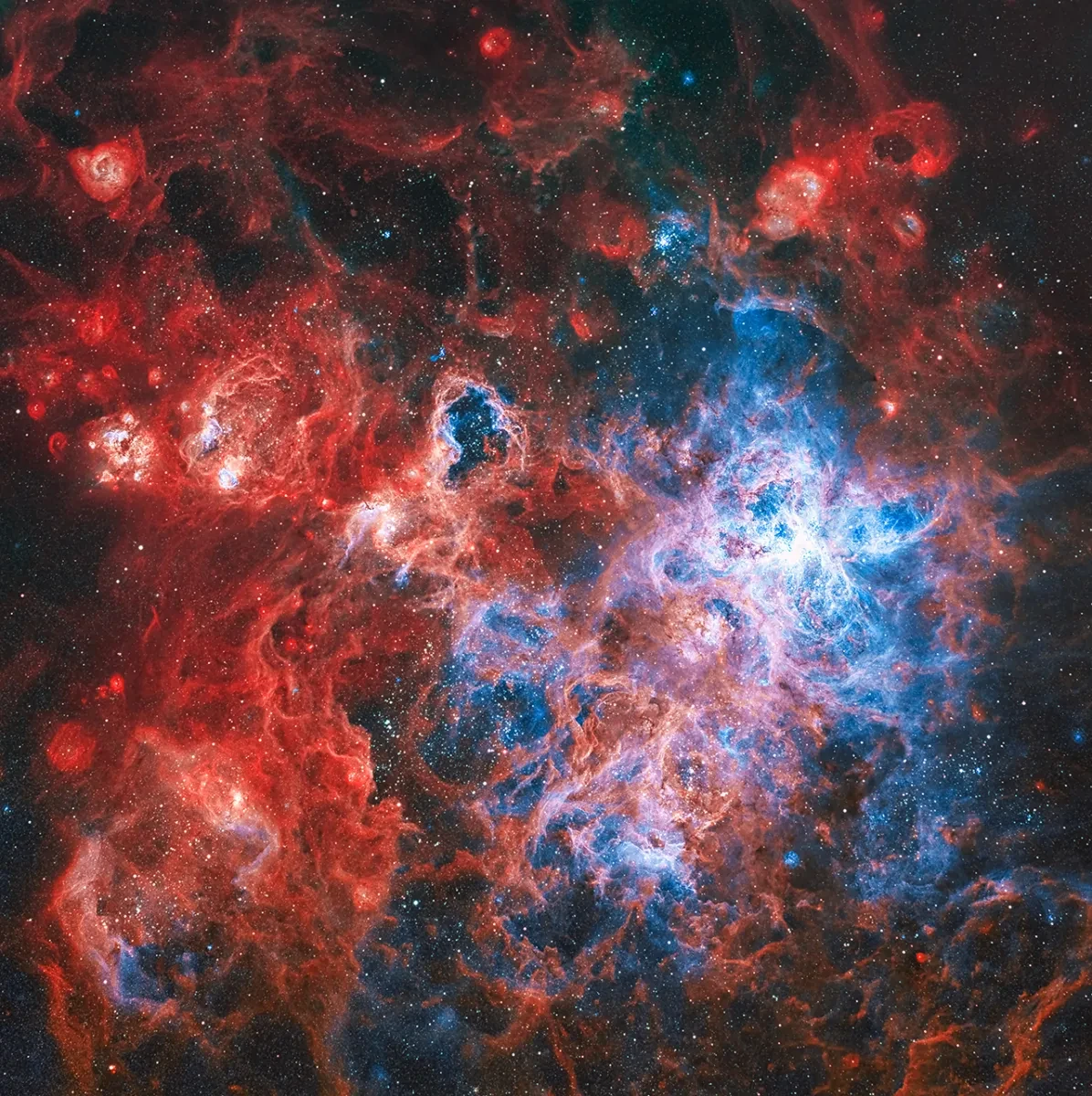 Image of black starry sky with multiple layers of nebula, in dark red, light red, dark blue and light blue