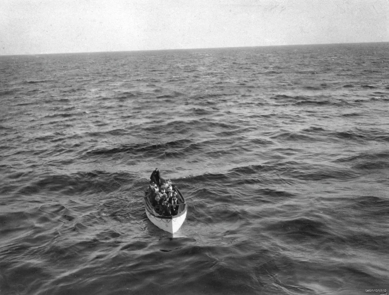 Historic black and white photograph showing one of the surviving lifeboats of the Titanic disaster, taken from the deck of the Carpathia