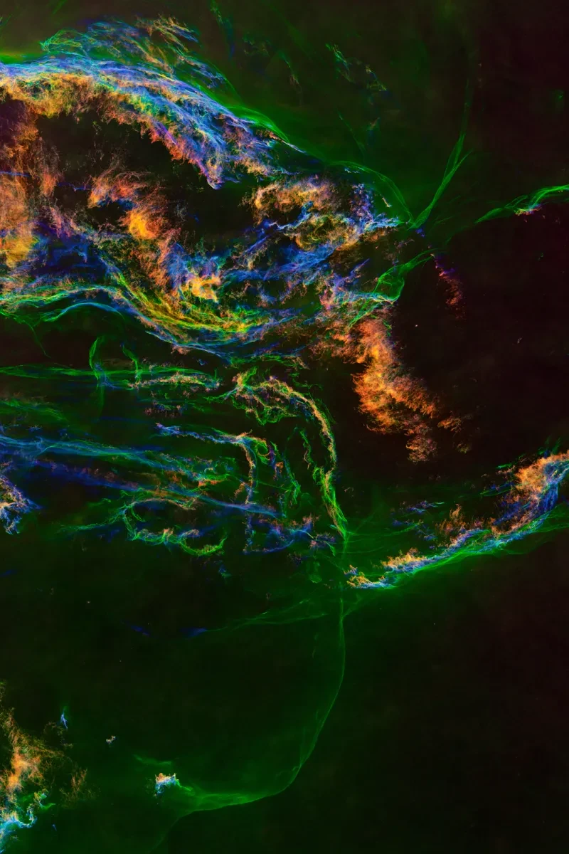 A green, orange and purple swirling nebula