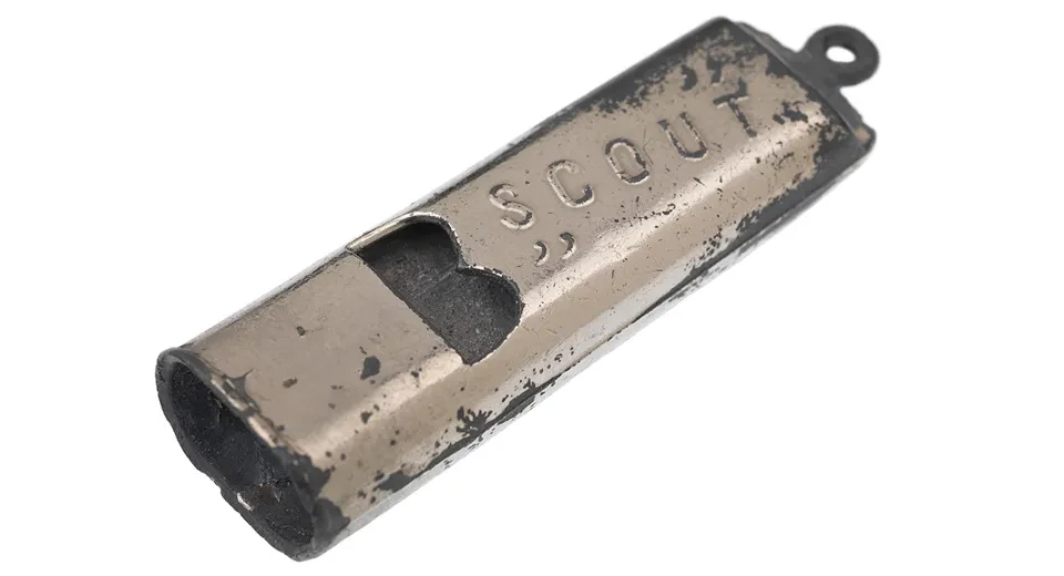 An aged silver-coloured whistle.